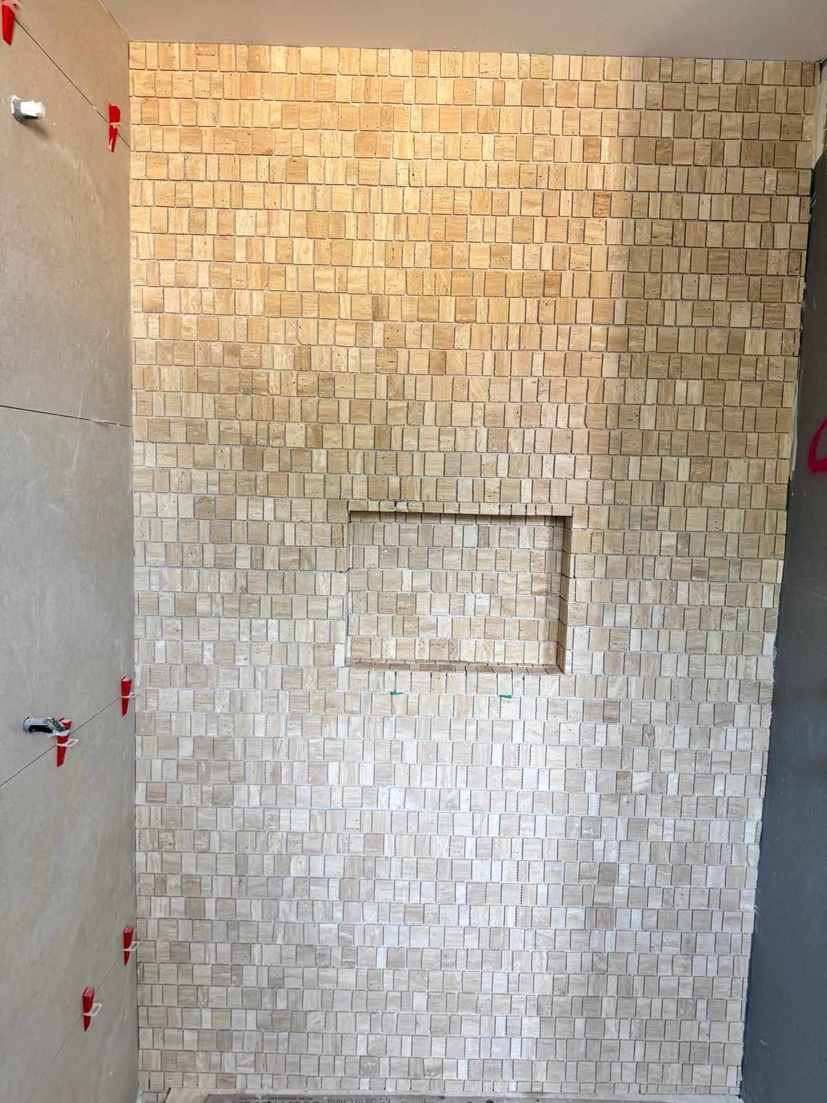 Mosaic shower wall over a sealed substrate